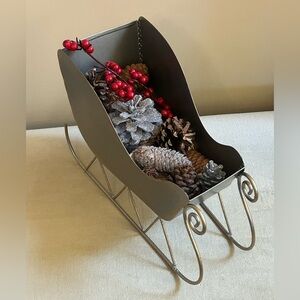 Festive Gray Sleigh with Pinecones and Red Accents